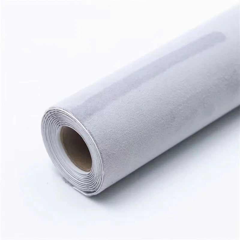 Rolls of self-adhesive leather suede in multiple colours showing texture and adhesive backing.