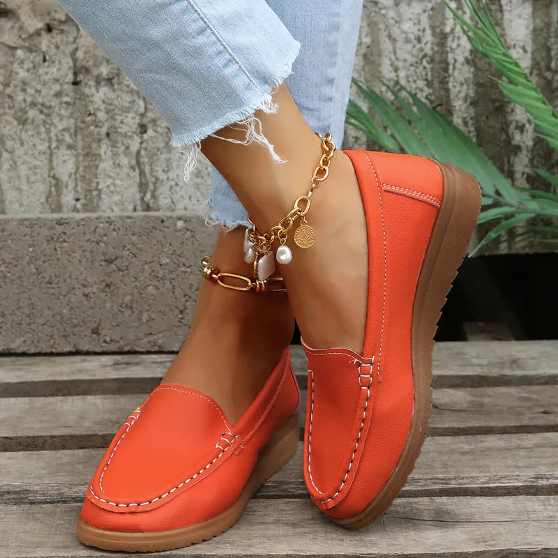 Women's flat shoes with car suture detailing on PU leather upper, round toe, rubber sole, available in multiple colours