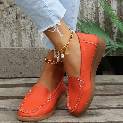 Women's flat shoes with car suture detailing on PU leather upper, round toe, rubber sole, available in multiple colours