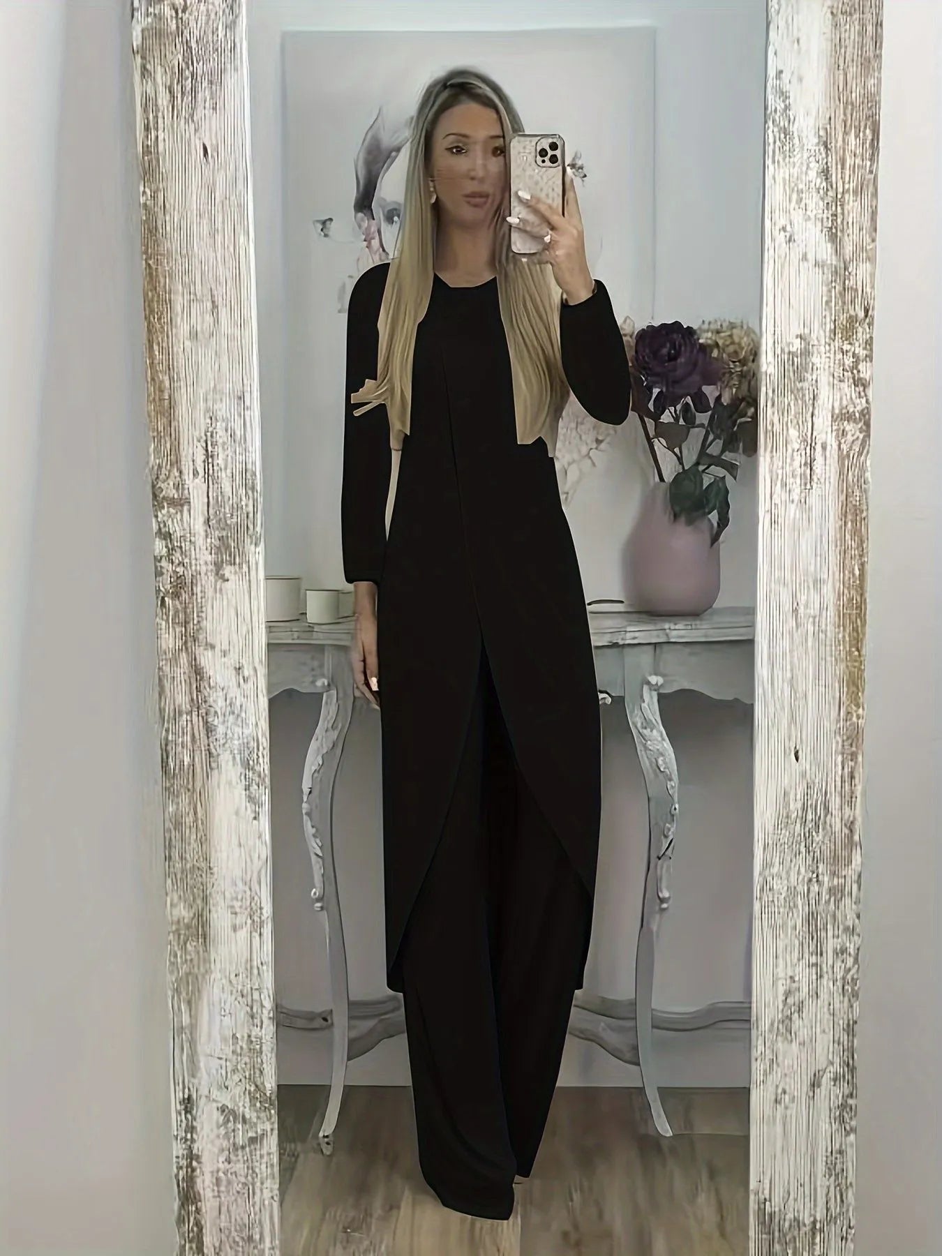 Casual black polyester two-piece lounge set with long sleeves and loose fit trousers on a hanger.