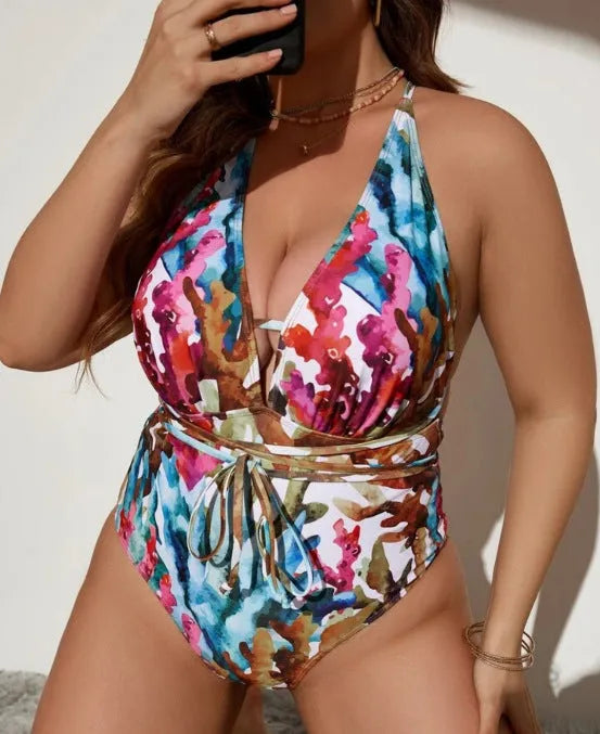 Purple women's one-piece halterneck swimsuit with brief cut on a mannequin, showing back and front detail.