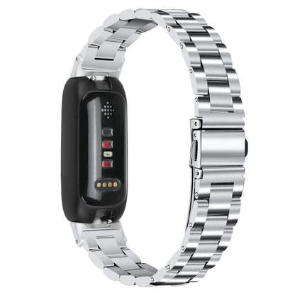 Three-bead stainless steel watch strap for Fitbit Inspire 3 in rose gold on a wrist