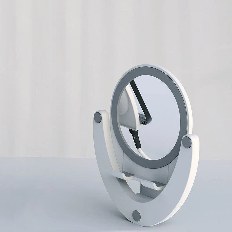 Adjustable mobile phone stand with integrated makeup mirror, featuring a sleek and versatile design for hands-free use and on-the-go touch-ups.