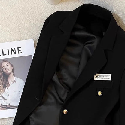 Black loose-fit women's short coat with long sleeves and pockets for college or commute wear.