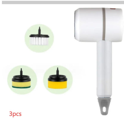 Green electric cleaning brush with scouring pad and brush heads on a kitchen worktop.