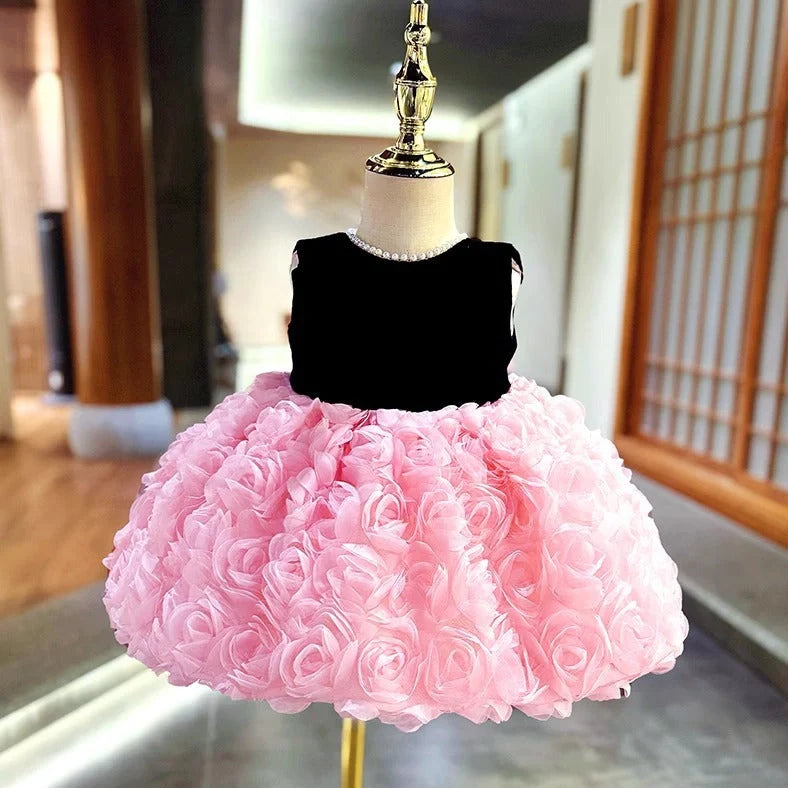 Pink girls summer dress with colour-matched design on hanger, showing polyester fabric texture