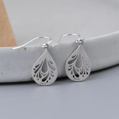 Retro hollow water drop shaped earrings in 925 silver with a textured grinding finish.