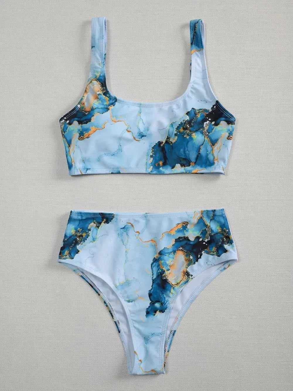 Women's high-waist bikini set with U-neck top in a blue marble tie-dye print.