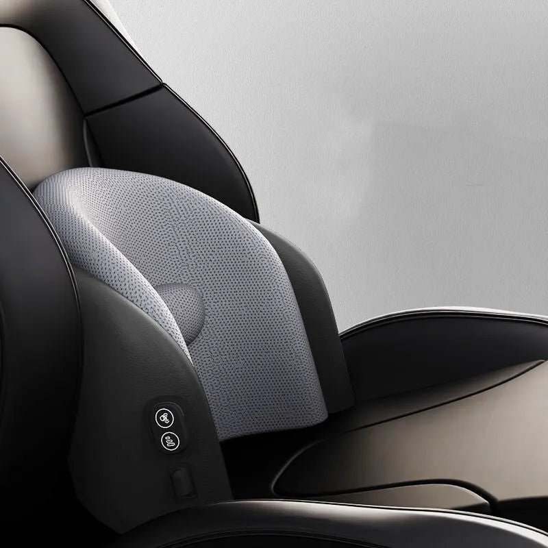 Black car massage cushion with adjustable straps attached to a car seat headrest