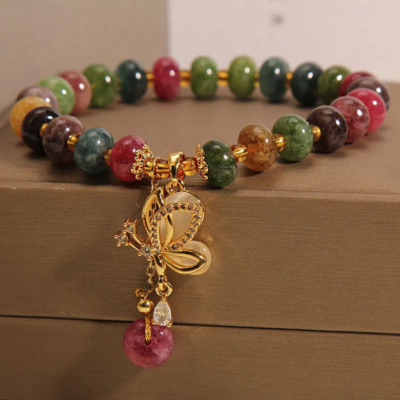 Colourful women's bracelet with butterfly charm, beads, and tourmaline accents on an alloy chain.