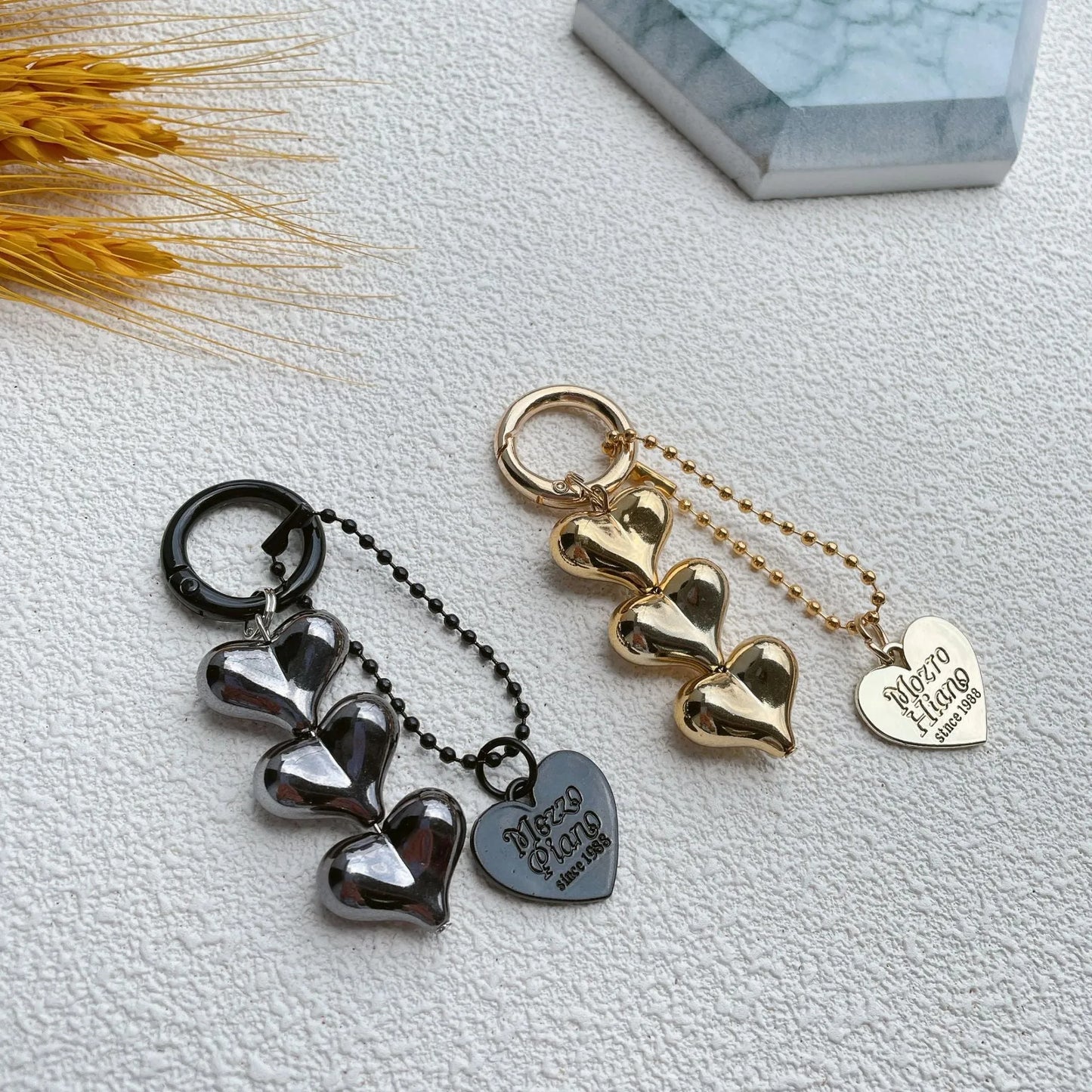 Acrylic key ring with an electroplated decorative charm in a choice of heart, bell, or water drop shapes.