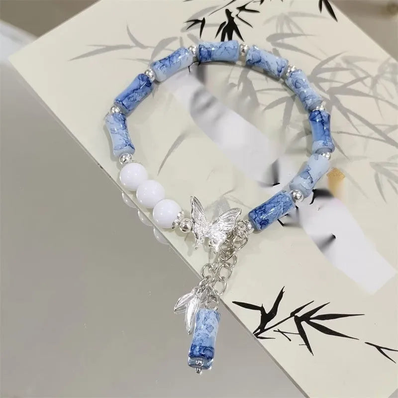 Chinese style glass bead bracelet with bamboo joint design on wrist.
