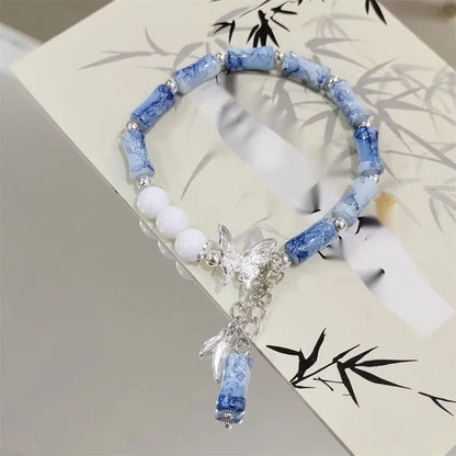 Chinese style glass bead bracelet with bamboo joint design on wrist.