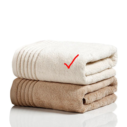 Beige and brown cotton towel set showing bath, hand, and face towel sizes.