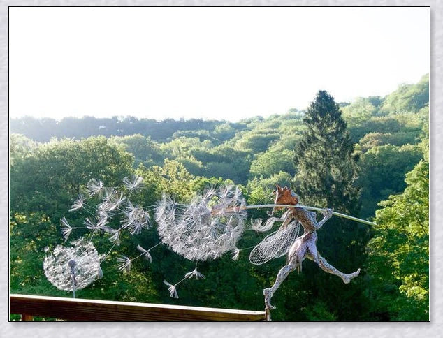 Metal fairy garden decoration with magical dandelions dancing in the wind, enchanting outdoor decor