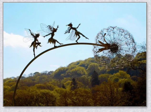 Metal fairy garden decoration with magical dandelions dancing in the wind, enchanting outdoor decor