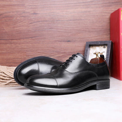 A pair of men's shoes made from premium cowhide with a gradient upper design and lace-up closure