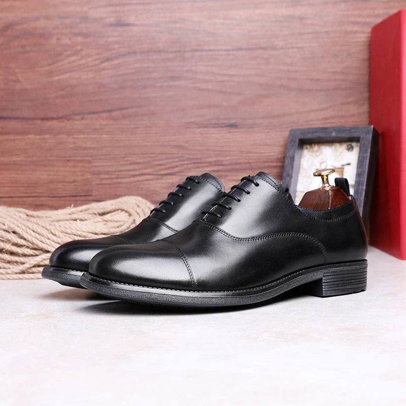 A pair of men's shoes made from premium cowhide with a gradient upper design and lace-up closure