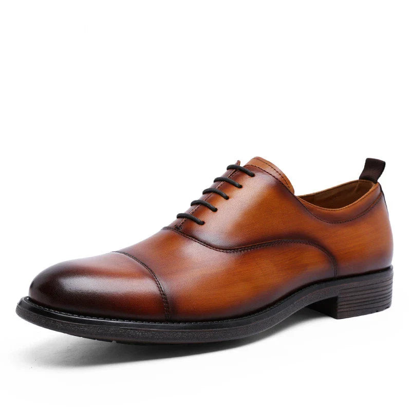 A pair of men's shoes made from premium cowhide with a gradient upper design and lace-up closure