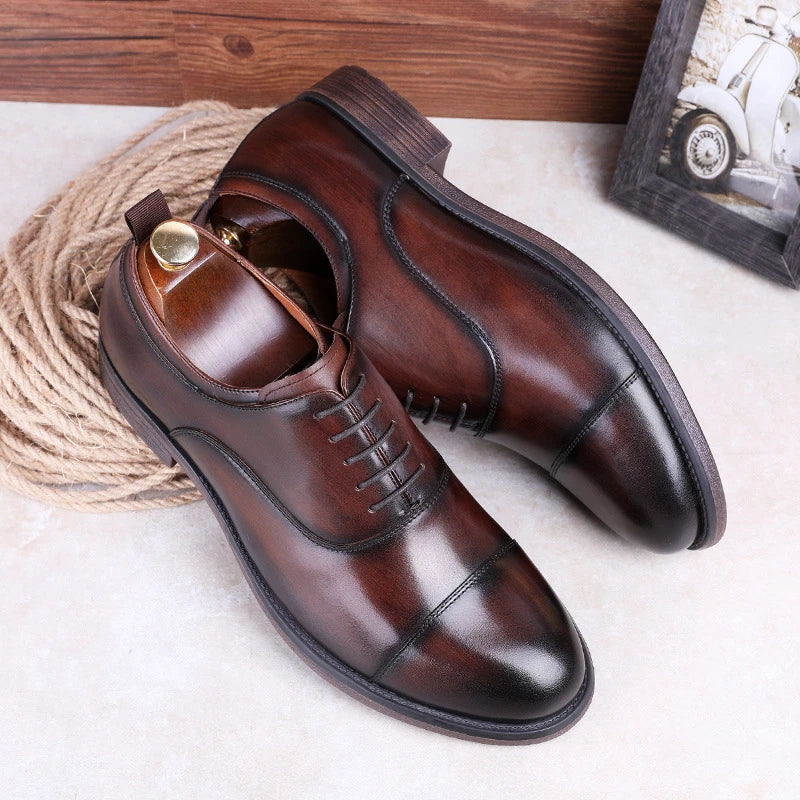 A pair of men's shoes made from premium cowhide with a gradient upper design and lace-up closure