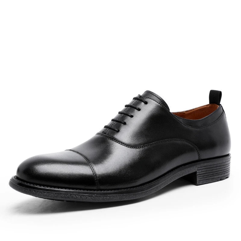 A pair of men's shoes made from premium cowhide with a gradient upper design and lace-up closure