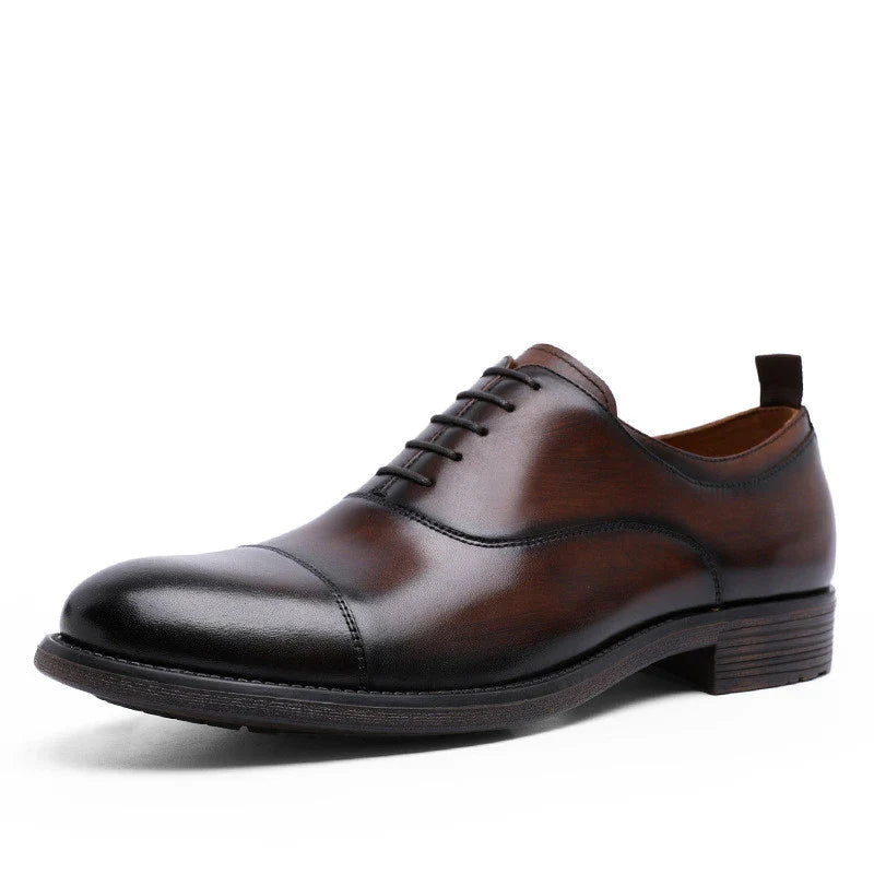 A pair of men's shoes made from premium cowhide with a gradient upper design and lace-up closure