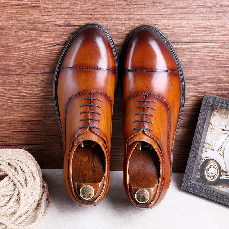 A pair of men's shoes made from premium cowhide with a gradient upper design and lace-up closure