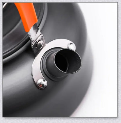 A complete camping cookware set including a teapot, cooking pot, and frying pan for convenient outdoor cooking and meal preparation
