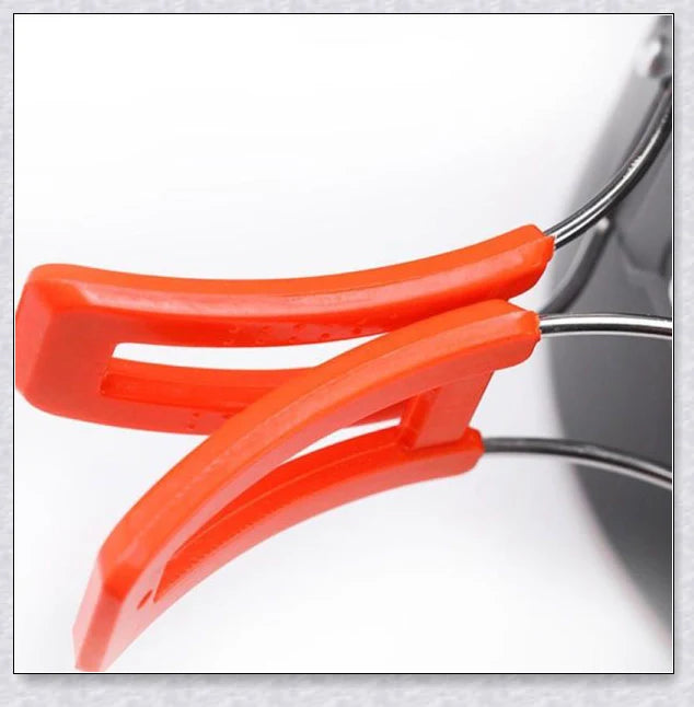 A complete camping cookware set including a teapot, cooking pot, and frying pan for convenient outdoor cooking and meal preparation