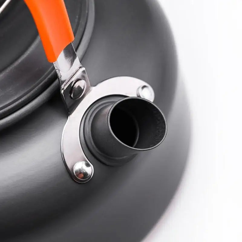 A complete camping cookware set including a teapot, cooking pot, and frying pan for convenient outdoor cooking and meal preparation