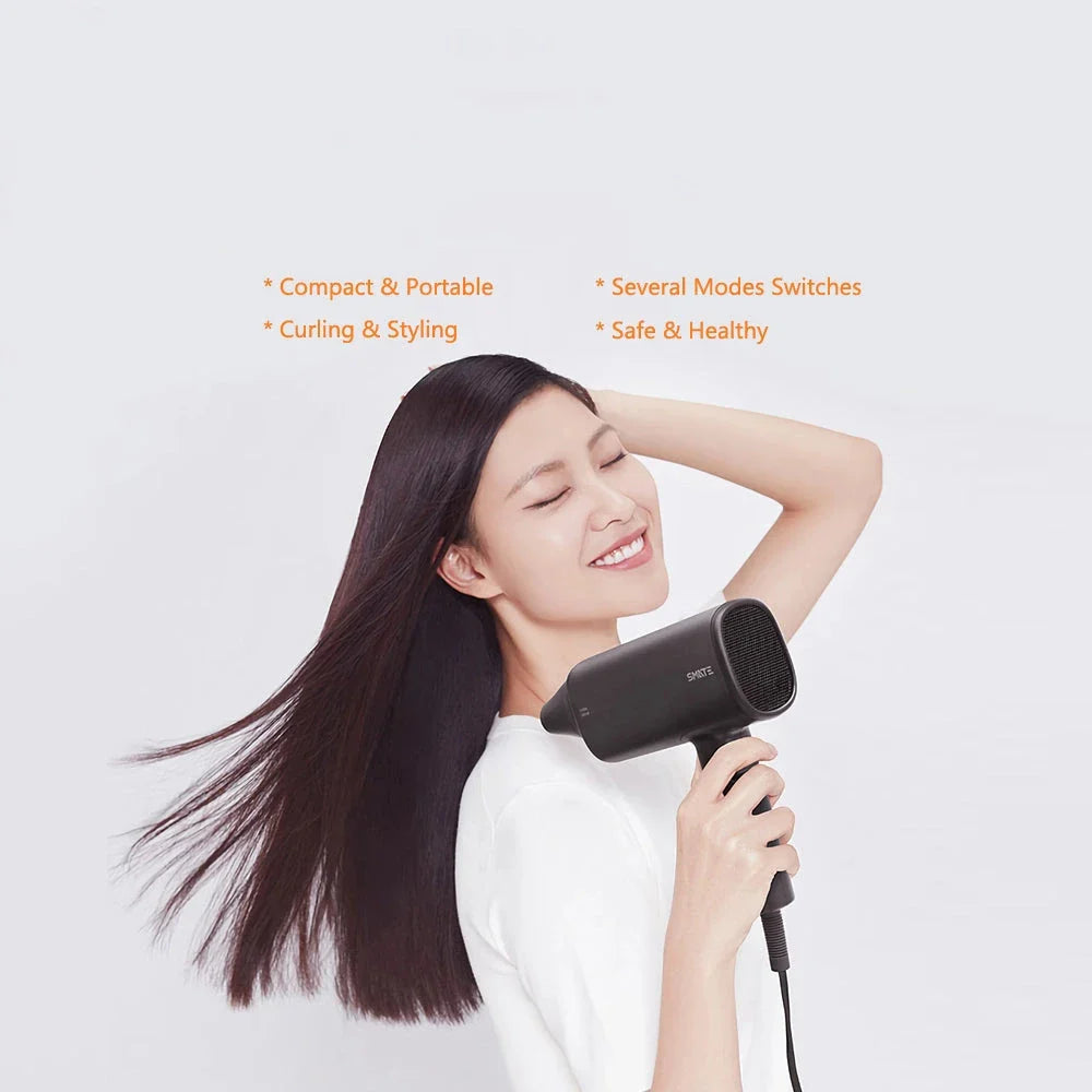 Compact, portable hair dryer with foldable handle and multiple styling settings for on-the-go hair care.