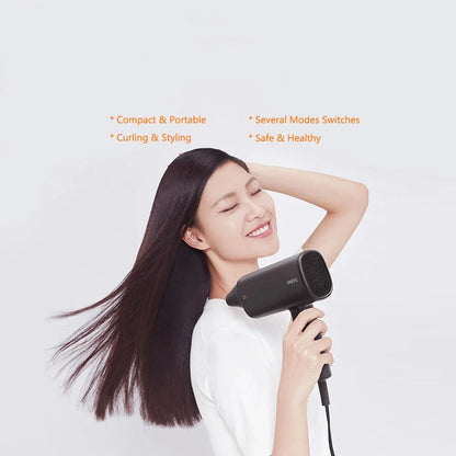 Compact, portable hair dryer with foldable handle and multiple styling settings for on-the-go hair care.