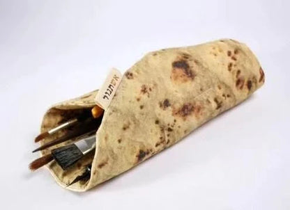 A unique, burrito-shaped pencil case made from high-quality fabric with a soft, comfortable grip