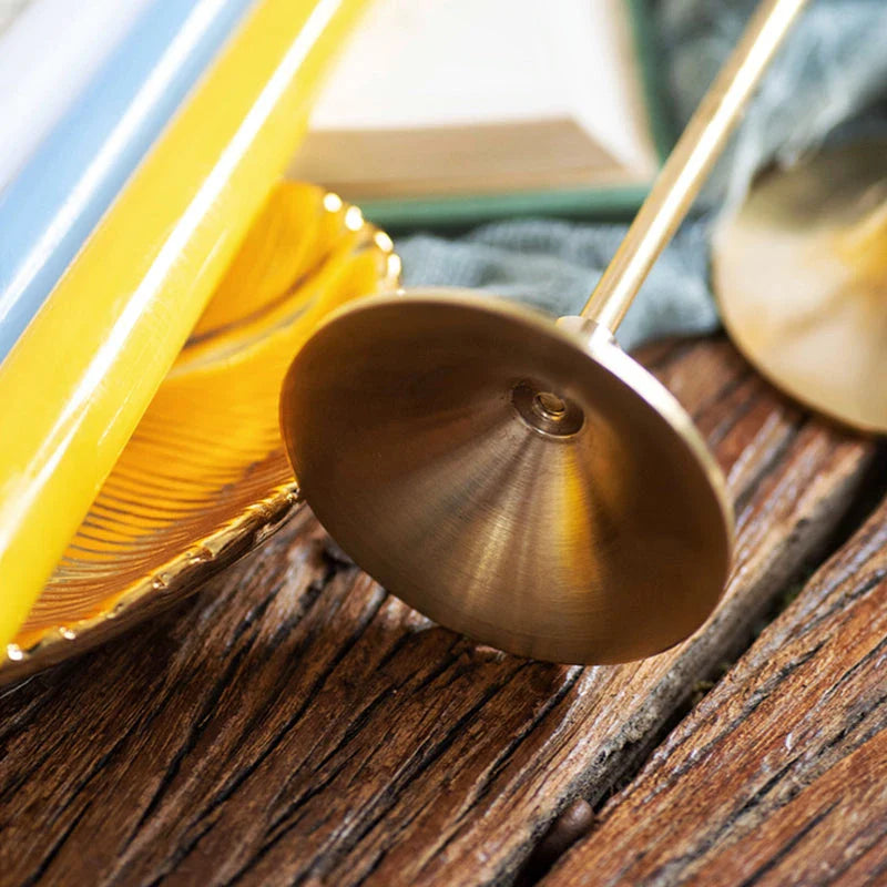 A set of three elegant brass gold candlestick holders on a wooden surface, creating a warm and inviting ambiance.