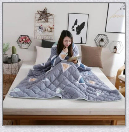 A cozy, wearable lazy quilt with sleeves in gray, providing hands-free warmth and comfort for relaxation and outdoor activities.