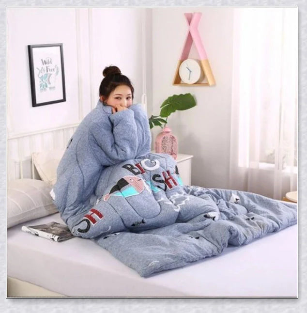 A cozy, wearable lazy quilt with sleeves in gray, providing hands-free warmth and comfort for relaxation and outdoor activities.