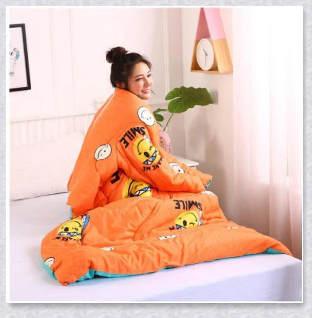 A cozy, wearable lazy quilt with sleeves in gray, providing hands-free warmth and comfort for relaxation and outdoor activities.