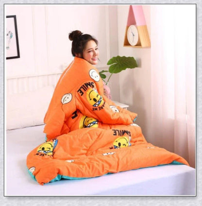 A cozy, wearable lazy quilt with sleeves in gray, providing hands-free warmth and comfort for relaxation and outdoor activities.