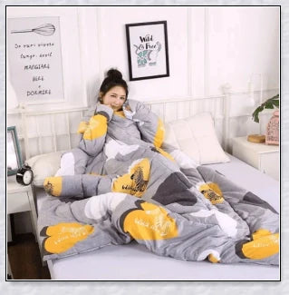 A cozy, wearable lazy quilt with sleeves in gray, providing hands-free warmth and comfort for relaxation and outdoor activities.