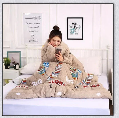 A cozy, wearable lazy quilt with sleeves in gray, providing hands-free warmth and comfort for relaxation and outdoor activities.
