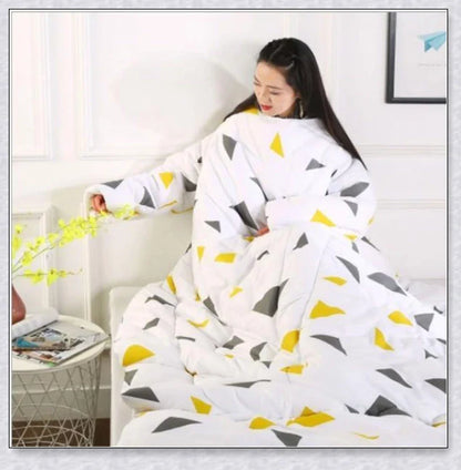 A cozy, wearable lazy quilt with sleeves in gray, providing hands-free warmth and comfort for relaxation and outdoor activities.