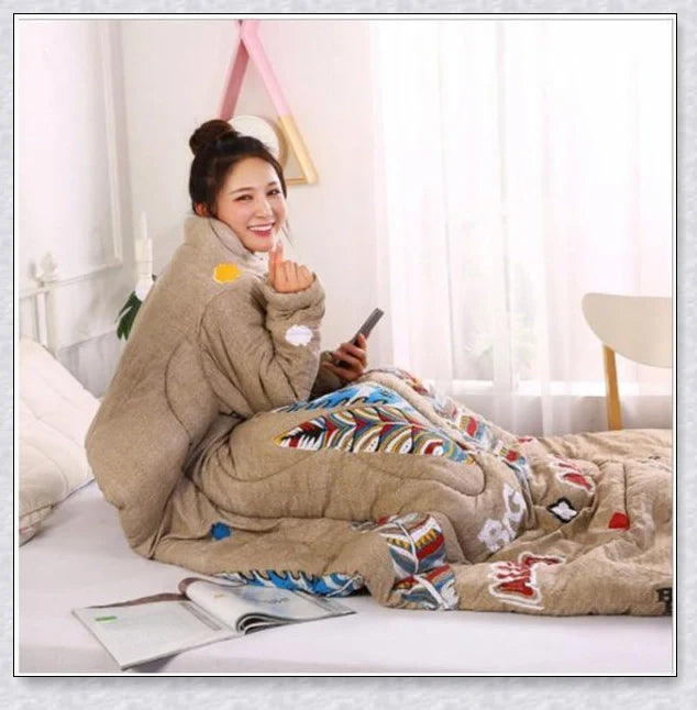 A cozy, wearable lazy quilt with sleeves in gray, providing hands-free warmth and comfort for relaxation and outdoor activities.