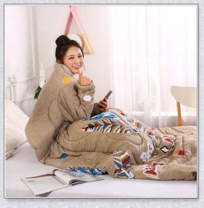 A cozy, wearable lazy quilt with sleeves in gray, providing hands-free warmth and comfort for relaxation and outdoor activities.
