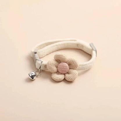 A soft, plush flannelette collar with a cartoon-style flower design and a bell to help locate your pet.