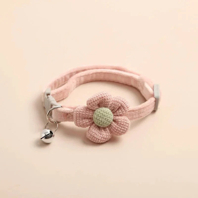 A soft, plush flannelette collar with a cartoon-style flower design and a bell to help locate your pet.
