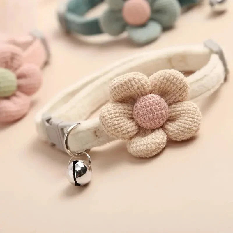 A soft, plush flannelette collar with a cartoon-style flower design and a bell to help locate your pet.
