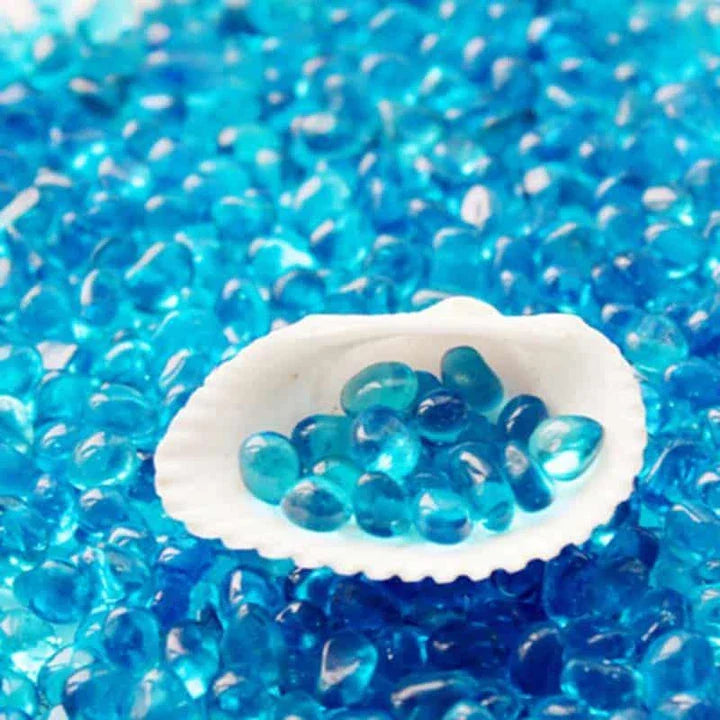 Premium blue gravel for aquarium decoration, featuring vibrant shades and a smooth texture to create a serene and calming underwater environment.