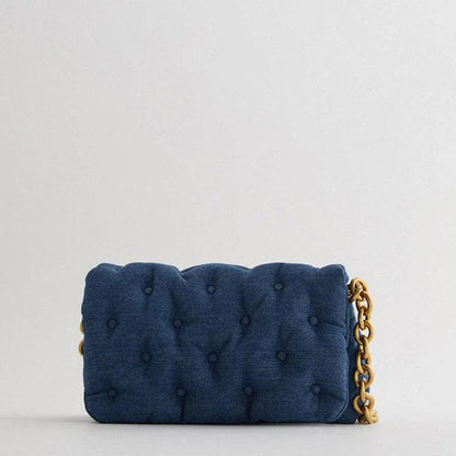 Blue oversized denim quilted shoulder messenger bag with chain strap and multiple interior pockets for organization