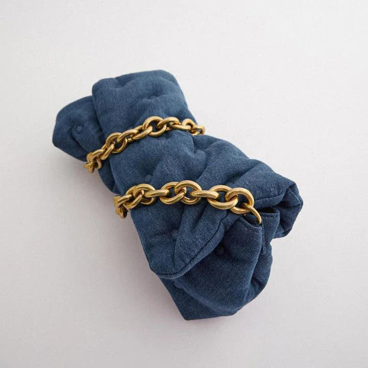 Blue oversized denim quilted shoulder messenger bag with chain strap and multiple interior pockets for organization