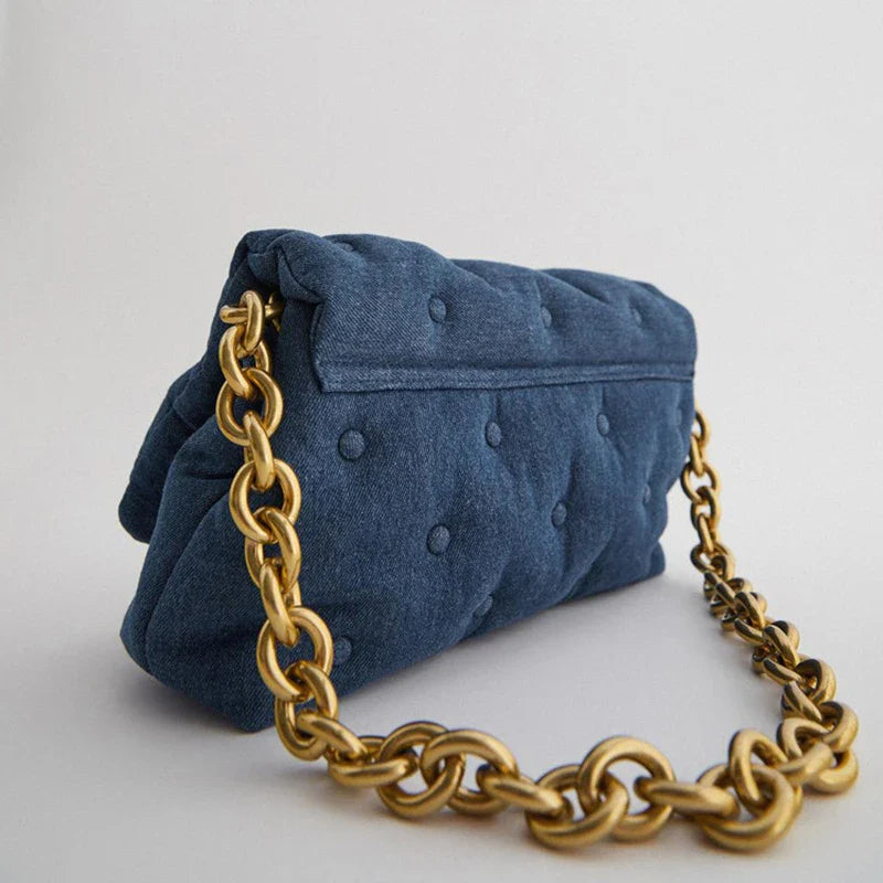 Blue oversized denim quilted shoulder messenger bag with chain strap and multiple interior pockets for organization